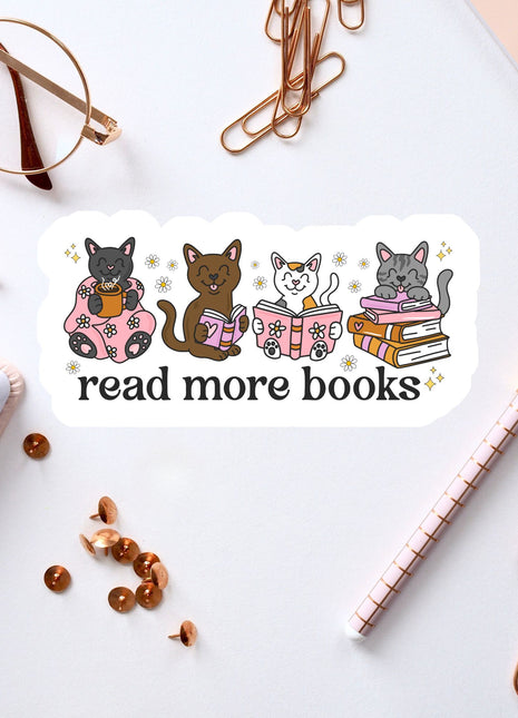 a sticker with a cat illustration and the text "read more books" on a white background. The sticker is surrounded by various office supplies, such as a pen, a pair of glasses, and some books.