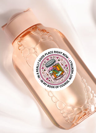 A pink bottle with a label that says "In a real good place right now, I'm not really in my book of course, not my book of course"