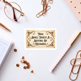 a sticker with a quote, surrounded by various office supplies such as pens, a notebook, and a pair of glasses.