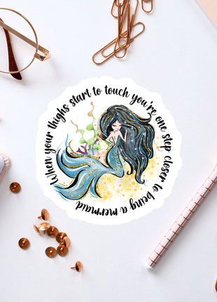 a sticker with a picture of a mermaid on it