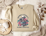 a beige sweatshirt with a graphic design depicting a skull surrounded by flowers and books, along with the text "Emotionally Attached to Fictional Characters".