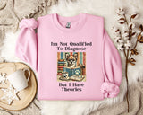 A pink sweatshirt with a humorous text and an illustration of a dog wearing glasses, sitting in front of a stack of books.