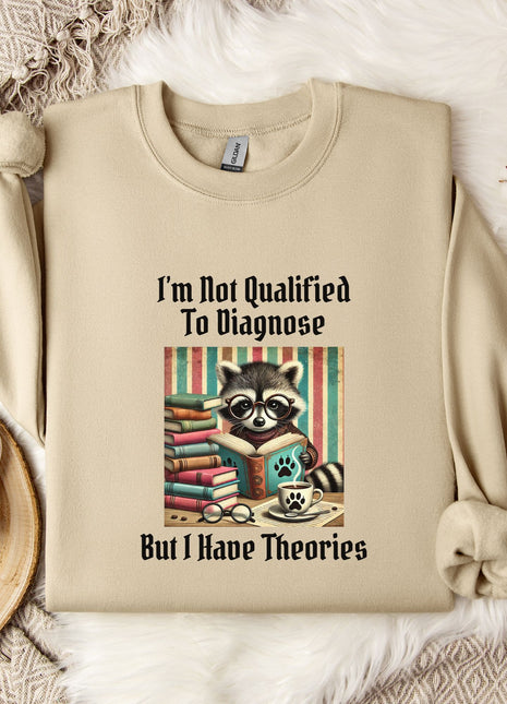 a beige sweatshirt with a graphic design of a raccoon reading a book, accompanied by the text "I'm Not Qualified To Diagnose But I Have Theories".