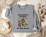 a gray sweatshirt with a graphic design of a raccoon reading a book, accompanied by the text "I'm Not Qualified To Diagnose But I Have Theories".