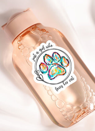 A pink bottle with a label featuring a paw print and the text "Just a girl who loves her cat".