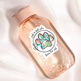 A pink bottle with a label featuring a paw print and the text "Just a girl who loves her cat".