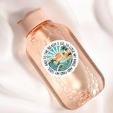 A clear glass bottle with a label featuring a beach scene and the text "I go to the beach I lose my mind".