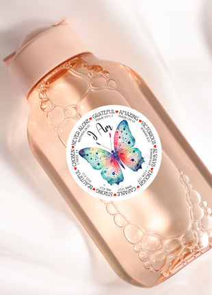 a close up of a bottle with a butterfly on it