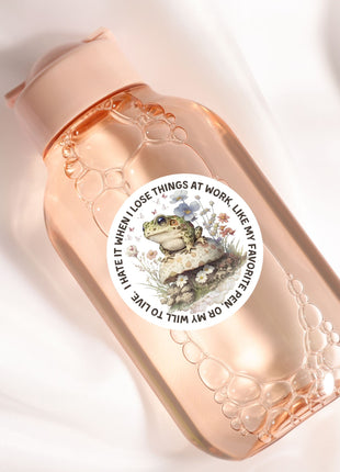 A pink bottle with a label featuring a frog and the text "I hate it when I lose things at work like my favorite".