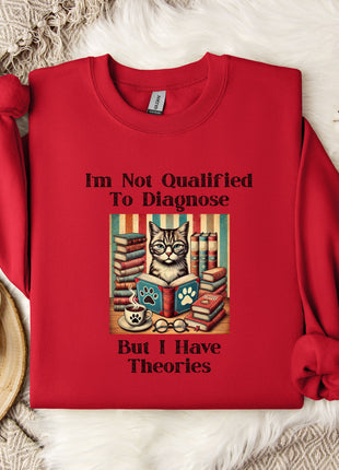A red sweater with a humorous text printed on it, placed on a white fur rug. The sweater features a cat surrounded by books and a cup, with the text "I'm Not Qualified To Diagnose" and "But I Have Theories" printed on it.