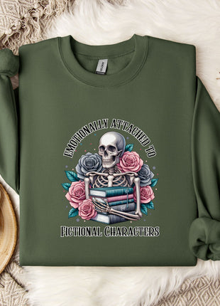 a green sweatshirt with a graphic design of a skeleton holding a book and flowers, accompanied by the text "I DON'T CARE ABOUT ANYTHING" and "FICTIONAL CHARACTERS".