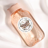 a close up of a bottle with a butterfly on it