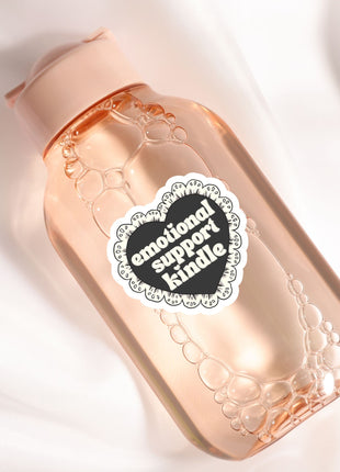 A pink bottle with a heart-shaped label that says "emotional support"