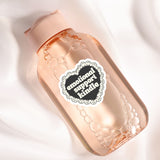 A pink bottle with a heart-shaped label that says "emotional support"