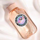 a close up of a bottle on a white surface