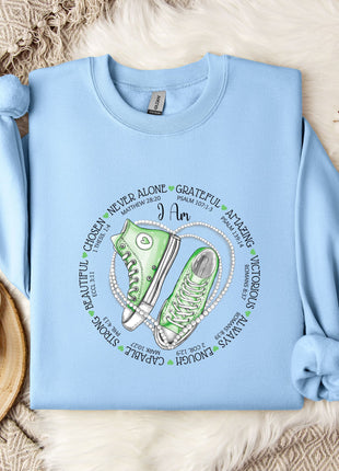 a blue shirt with a pair of sneakers on it