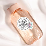 A pink bottle with a label that says "The Lord is strong and powerful" and has a floral design.