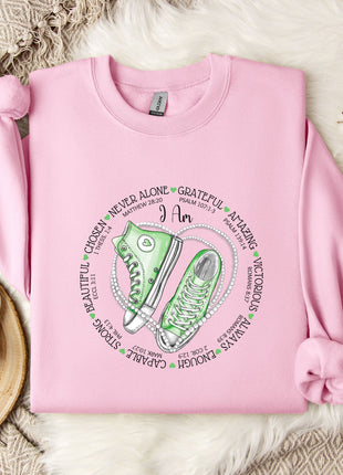 a pink sweater with a green sneaker on it