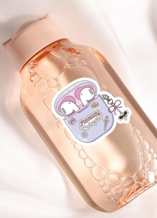 A pink bottle with a label featuring a pair of cartoon ears and the text "Fantastical AudioPods" is shown against a white background.