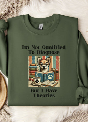 a green sweatshirt with a printed design on it, including a cat wearing glasses and surrounded by books, along with the text "I'm Not Qualified To Diagnose But I Have Theories".