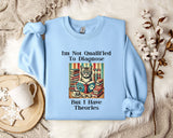 A light blue sweatshirt with a humorous text and an illustration of a cat surrounded by books, placed on a bed with a white blanket and a mug.