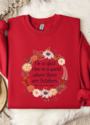 A red sweater with a floral design and a quote printed on it, along with a mug, a white mug, and some white flowers on a white fur rug.