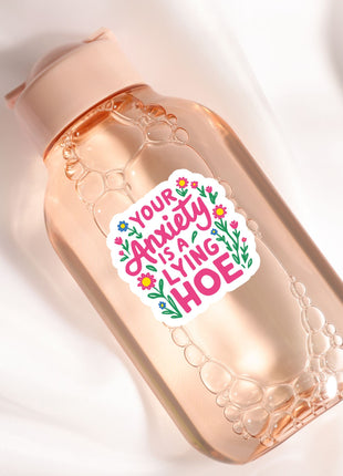 a bottle with a sticker on it sitting on a white surface