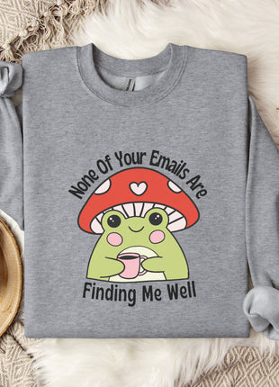 a gray sweatshirt with a cartoon frog wearing a red mushroom hat and holding a cup, accompanied by the text " none of your emails are finding me well".