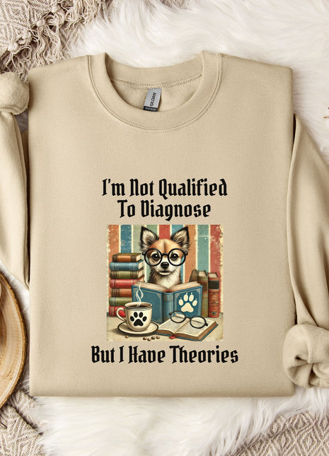 a beige sweatshirt with a printed design of a cat wearing glasses and surrounded by books, along with the text "I'm Not Qualified To Diagnose But I Have Theories".