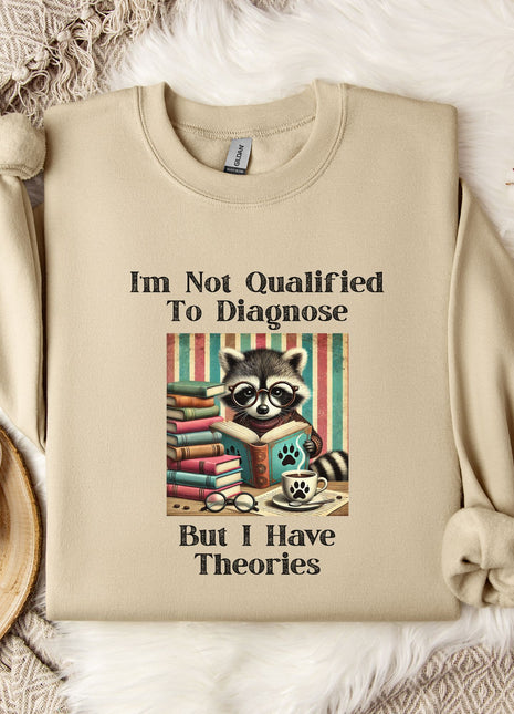 a beige sweatshirt with a graphic design of a raccoon surrounded by books and a cup of coffee, along with text that reads "I'm Not Qualified To Diagnose But I Have Theories".