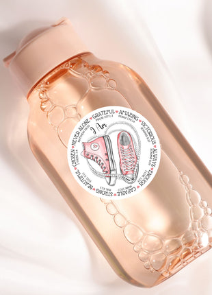 a bottle with a sticker on it sitting on a white surface