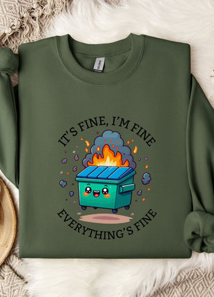 a green sweatshirt with a graphic design depicting a trash can with flames coming out of it, accompanied by the text "It's fine, I'm fine Everything's fine".