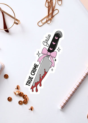 a sticker of a knife with a pink bow on it