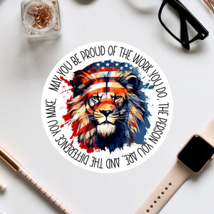 a circular sticker with a lion's face and an American flag design, surrounded by text that reads "May you be proud of the work you do, the person you are, and the difference you make".