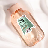 a bottle with a sticker on it sitting on a white surface