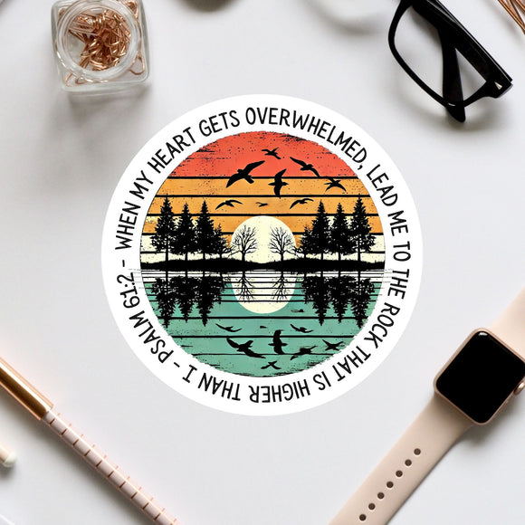 a circular design with a sunset and silhouetted trees scene, along with a Bible verse reference.