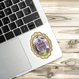 a sticker of a castle on a laptop keyboard, placed on a wooden surface.