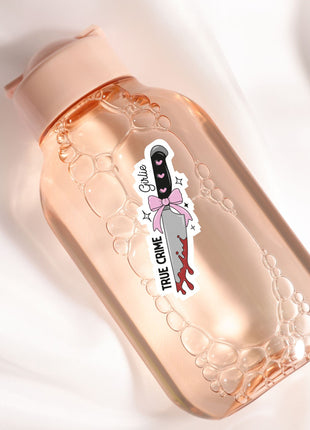 a bottle with a sticker on it sitting on a white surface