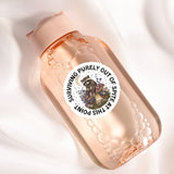 a pink bottle with a sticker of a dog on it