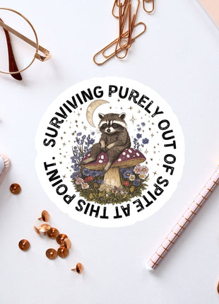 a sticker of a raccoon sitting on top of a table