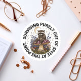 a sticker of a raccoon sitting on top of a table