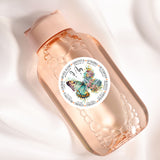 a pink bottle with a butterfly on it