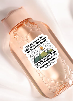 A pink bottle with a sticker featuring a mountain landscape and a Bible verse.