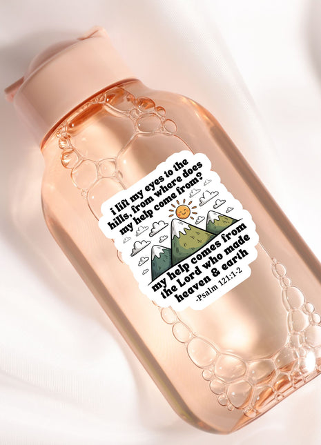 A pink bottle with a sticker featuring a mountain landscape and a Bible verse.