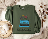 A green sweatshirt with a graphic design of a typewriter filled with colorful flowers, accompanied by the text "Emotionally Attached To Fictional Characters".