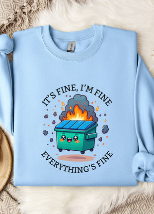 A light blue sweatshirt with a graphic design depicting a trash can on fire, accompanied by the text "It's fine, I'm fine Everything's fine".
