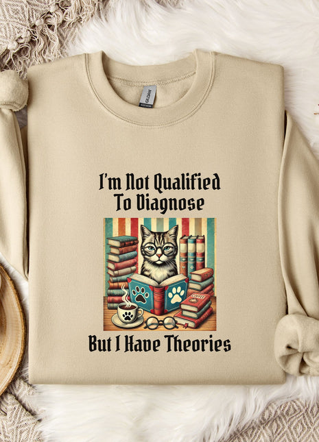 a beige sweatshirt with a printed design of a cat surrounded by books and a cup of coffee, along with the text "I'm Not Qualified To Diagnose But I Have Theories".