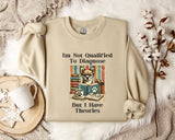 a beige sweatshirt with a humorous text and an illustration of a dog wearing glasses and a book, placed on a bed with a white blanket and a mug.