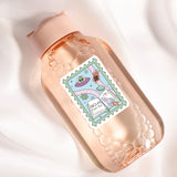 A pink bottle with a label featuring a cartoon illustration of a hand holding a book, surrounded by bubbles.