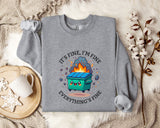 a gray sweatshirt with a graphic design depicting a green dumpster with flames coming out of it, accompanied by the text "It's fine, I'm fine Everything's fine".